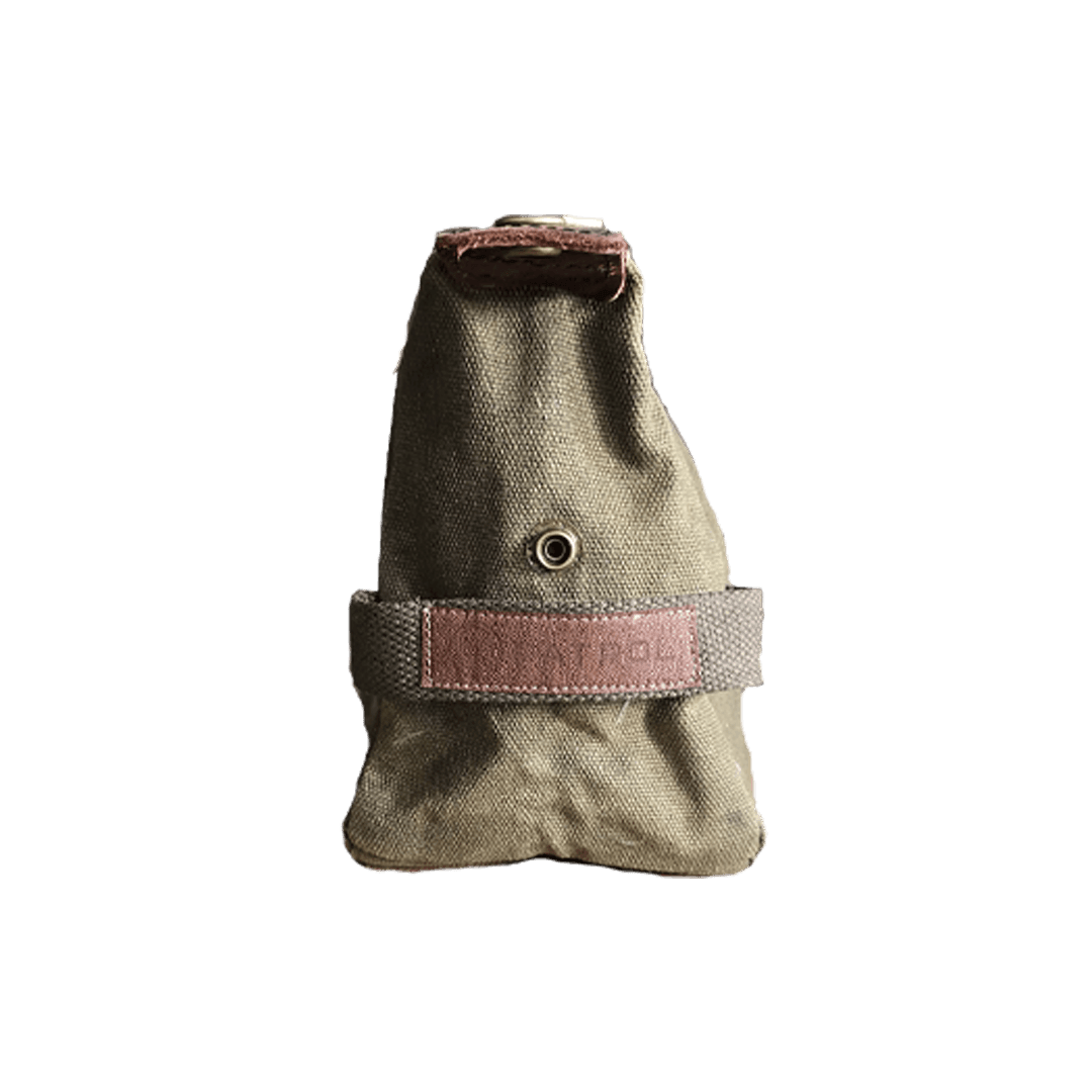 Patrol Goods olive waxed canvas washbag side view. Brown Faux leather patch sewn to cotton webbing handle. Rugged outdoor accessory.
