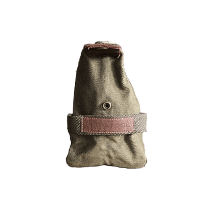 Patrol Goods olive waxed canvas washbag side view. Brown Faux leather patch sewn to cotton webbing handle. Rugged outdoor accessory.