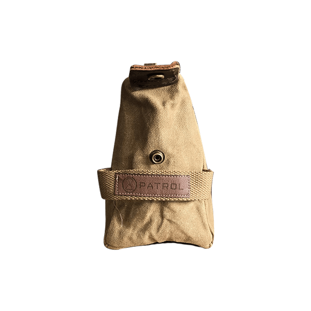 Patrol Goods sand waxed canvas washbag side view. Brown Faux leather patch sewn to cotton webbing handle. Rugged outdoor accessory.