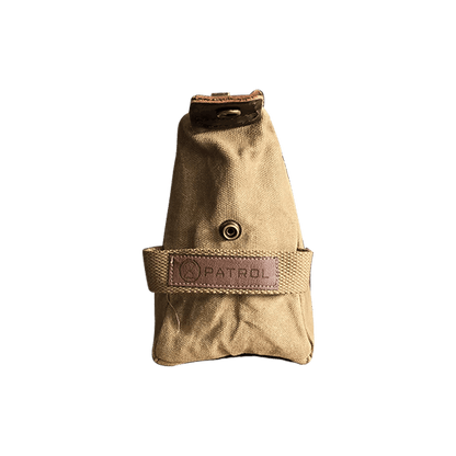 Patrol Goods sand waxed canvas washbag side view. Brown Faux leather patch sewn to cotton webbing handle. Rugged outdoor accessory.