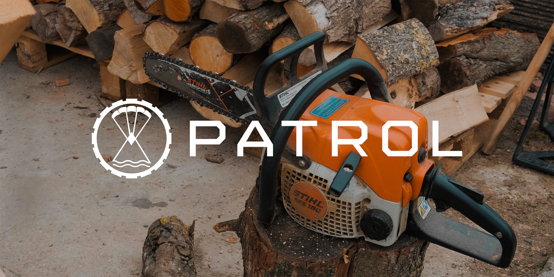 Chopping wood and starting a log fire wearing patrol clothing